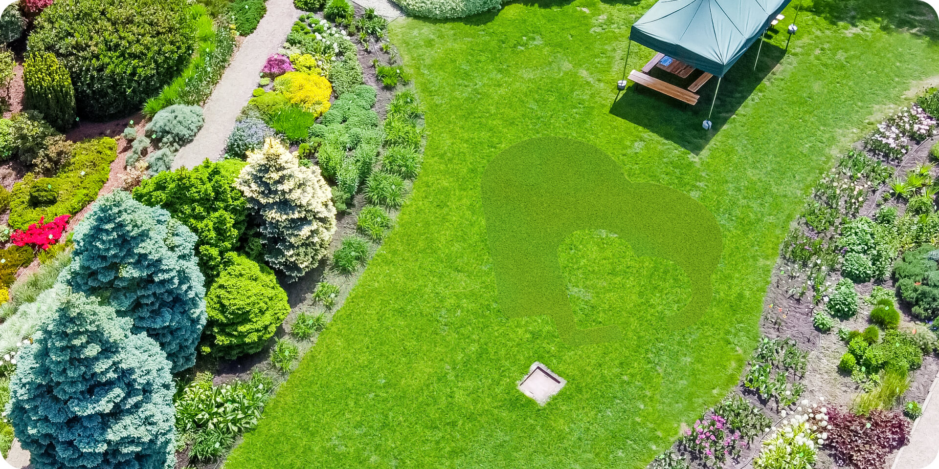 Navimow i110E robot lawn mower mows heart shape on grass.