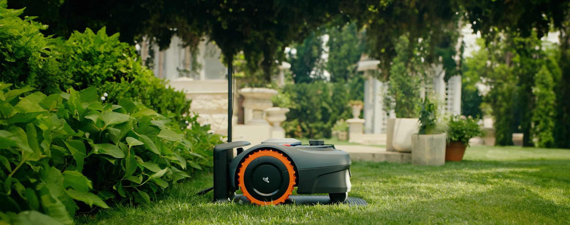 Navimow i105E robot lawn mower sits in the green garden.