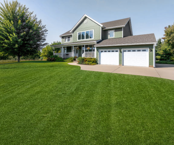 Navimow i110N robot lawn mower mows the large green yard.
