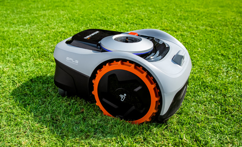 Segway Navimow i110N robot lawn mower sits on green grass.