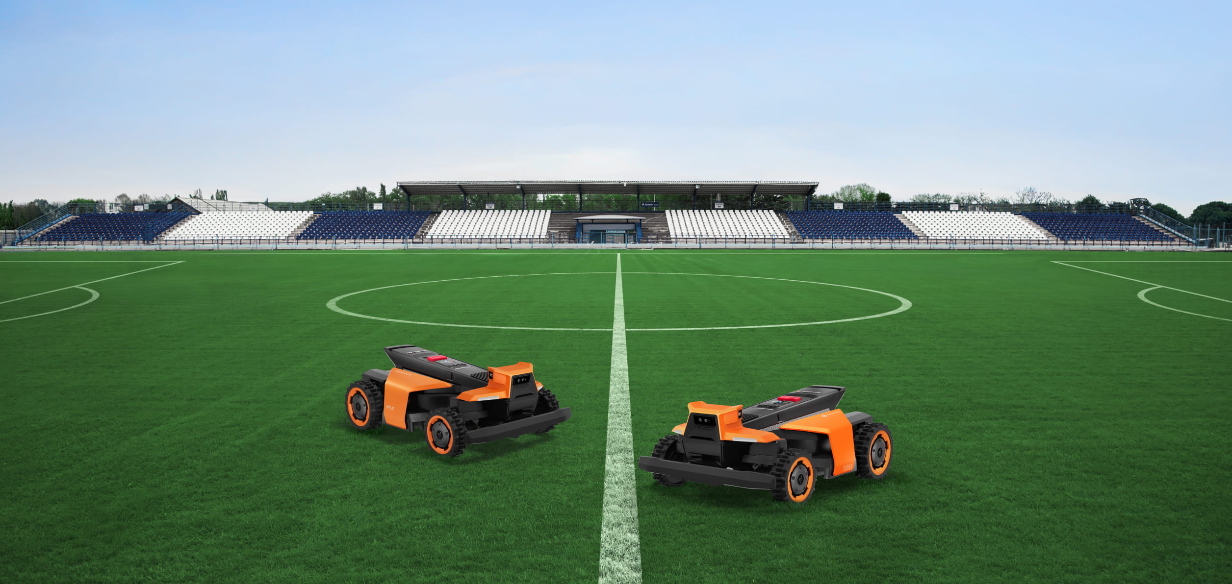 Navimow i Series robot lawn mowers on a soccer field.