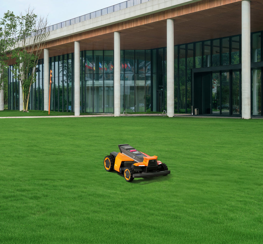 Navimow i110N robot lawn mower in front of glass building.
