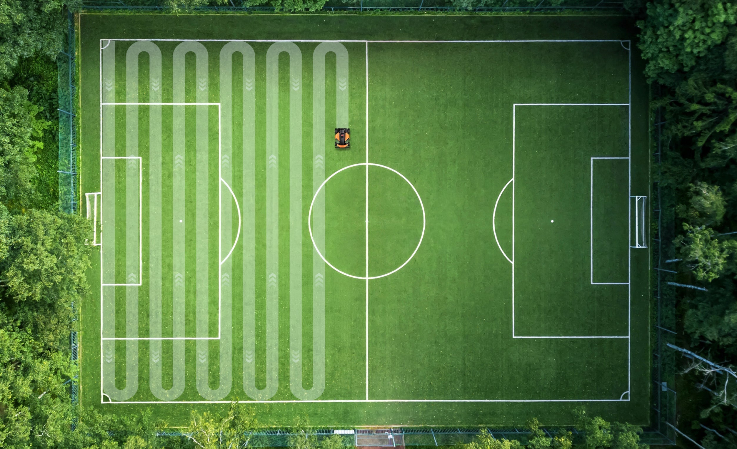 The Segway Navimow i110N robot lawn mower mows a field.