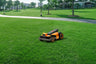 Segway Navimow i105E robot lawn mower on a green lawn.