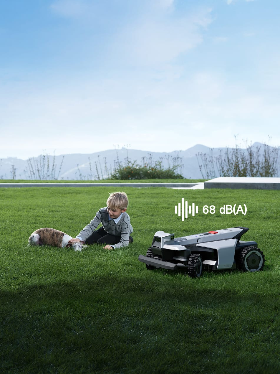 Navimow i110E robot lawn mower with a boy and dog.