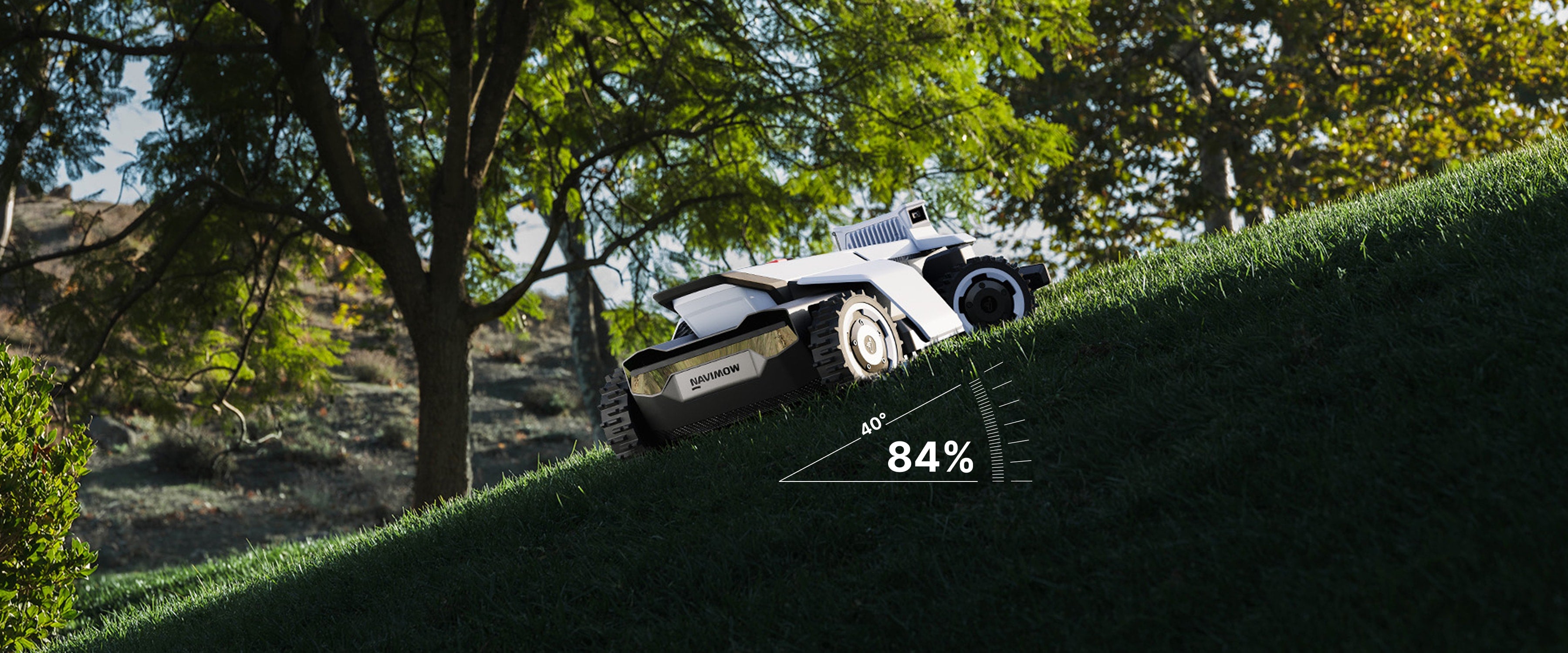 Segway Navimow i Series robot lawn mower climbing steep grassy hill.