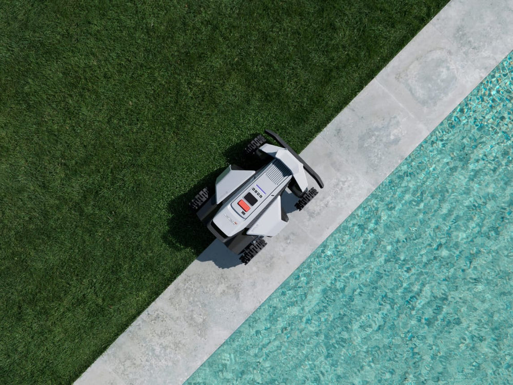 Navimow i110N robot lawn mower mows grass near a pool.