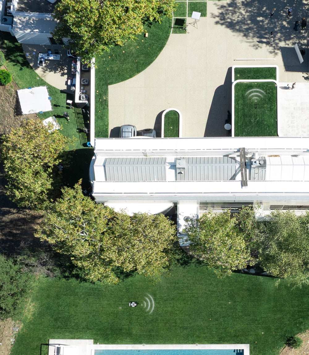 Segway Navimow i110E robot lawn mower in a modern backyard.