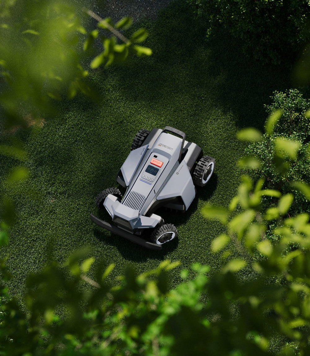 Navimow i110N robot lawn mower on a green grass lawn.