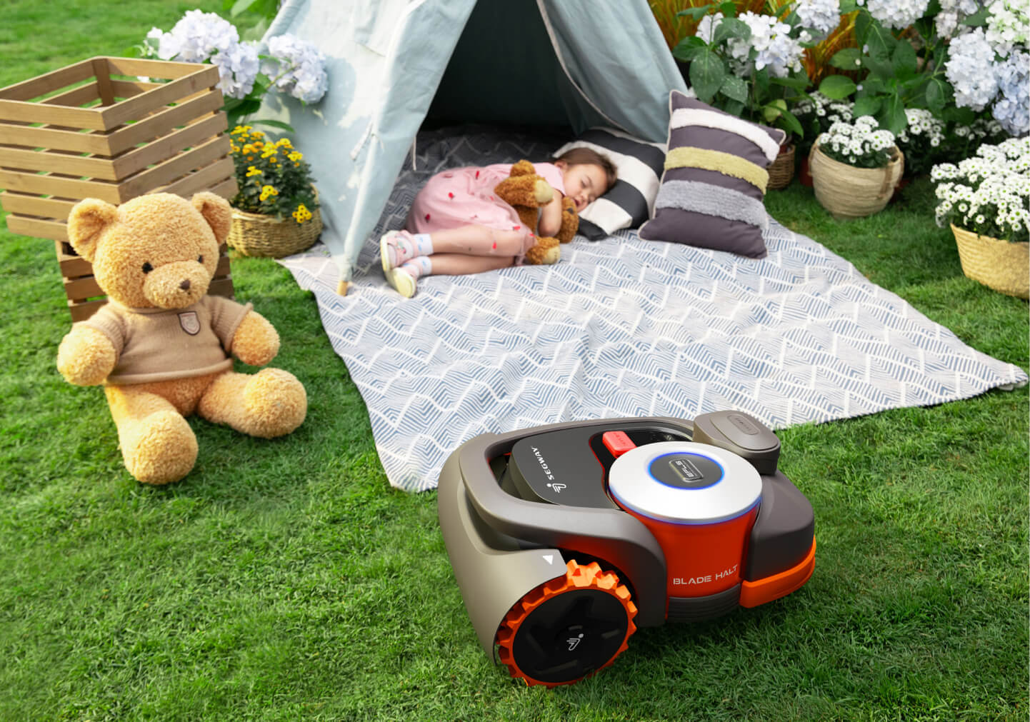 Segway Navimow i110N robot lawn mower near a sleeping child.