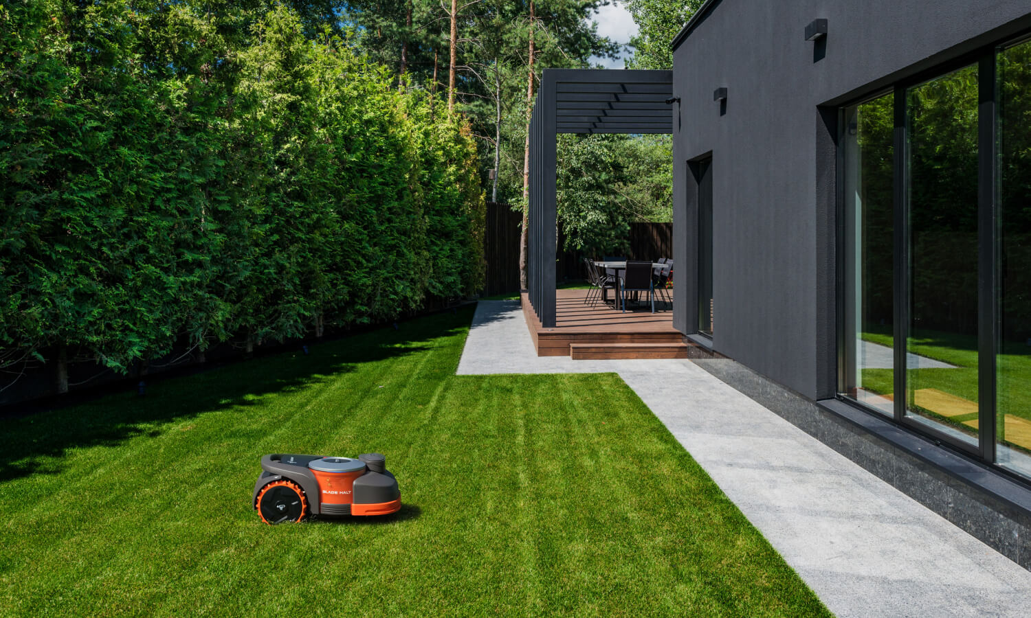 Navimow i110E robot lawn mower mows the green garden grass.