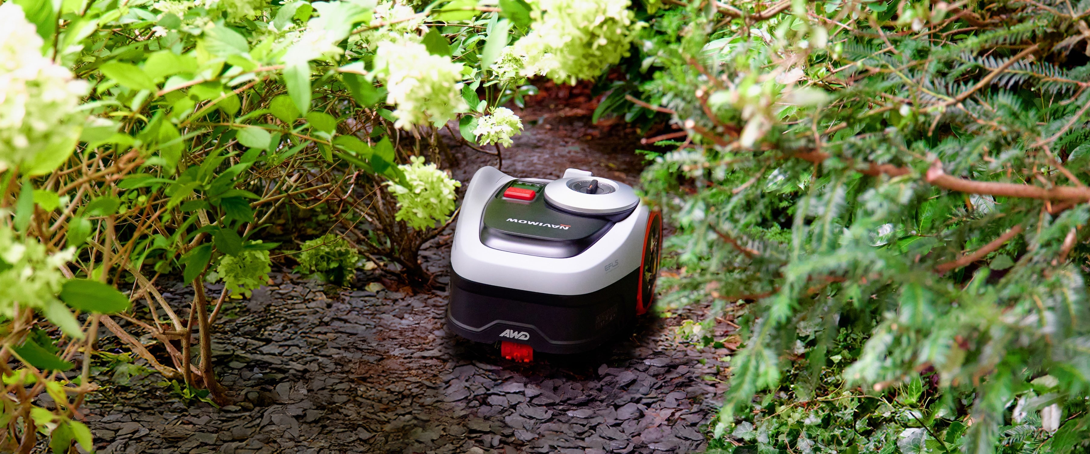 Navimow AWD robot lawn mower mows within the green garden.