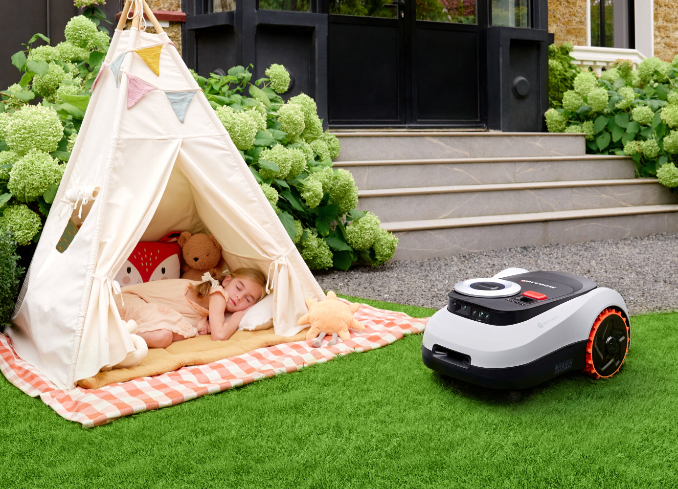 Segway Navimow i Series robot lawn mower near sleeping girl.