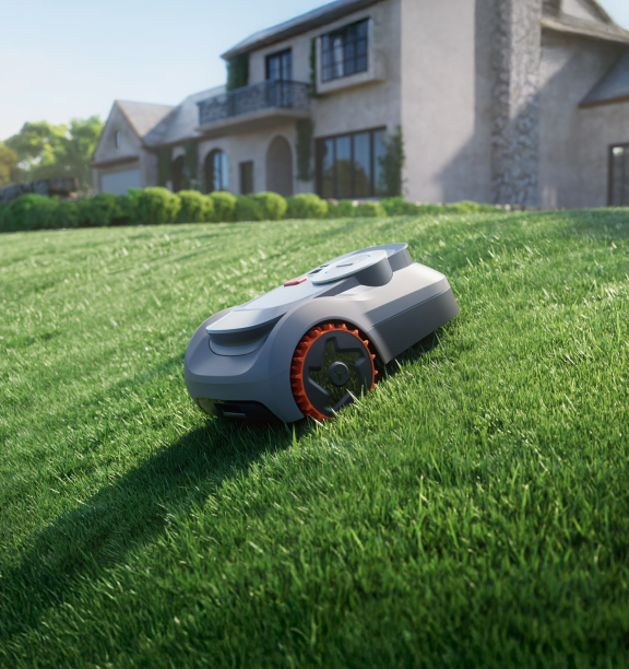 Segway Navimow i105E robot lawn mower on a grassy slope.