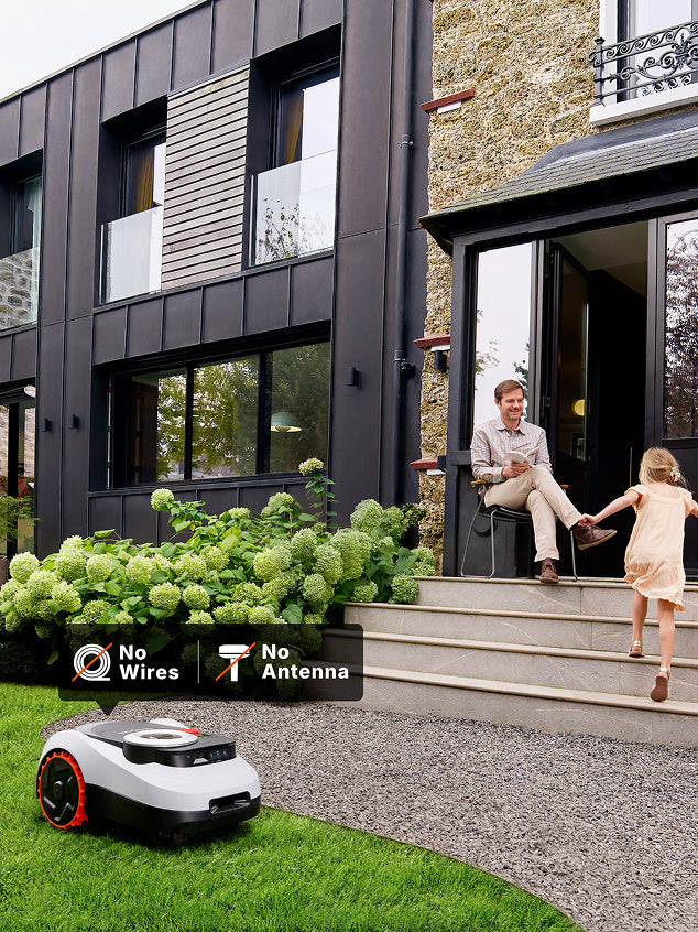 A Segway Navimow i105E robot lawn mower in the yard.