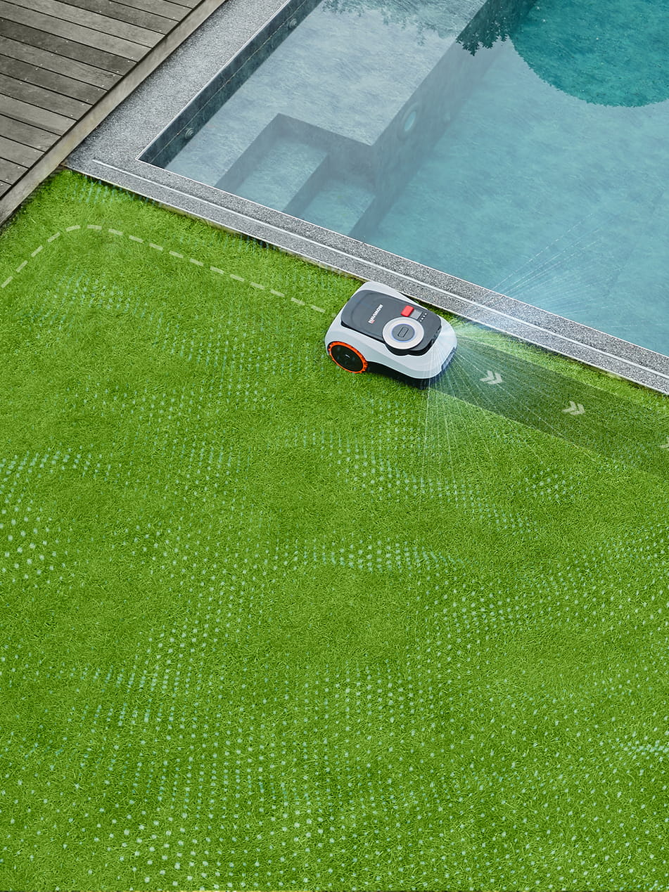Navimow i110N robot lawn mower mows the grass near pool.