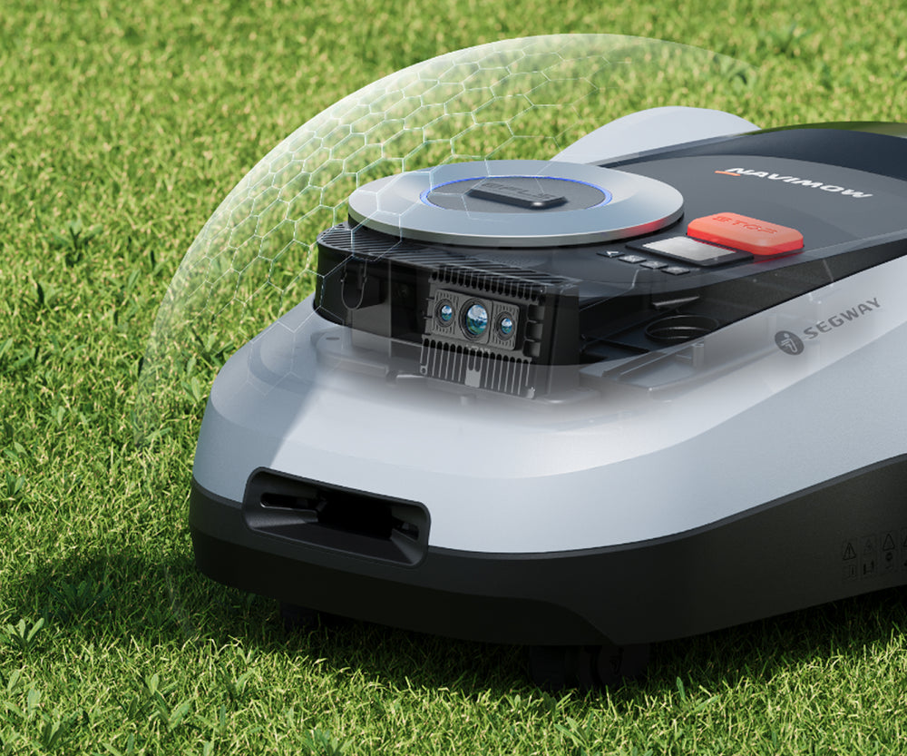 Segway Navimow robot lawn mower sitting on a green field.