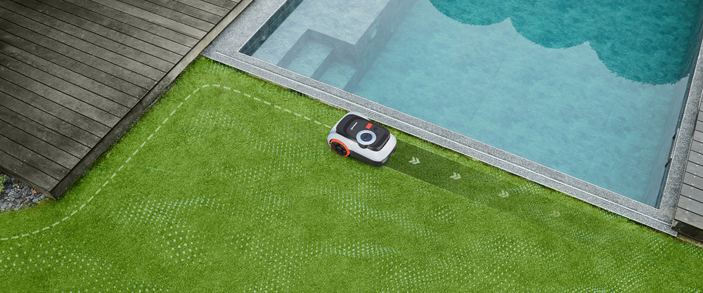Navimow i Series robot lawn mower mows grass near pool.