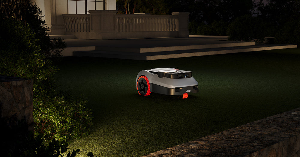 Navimow i110E robot lawn mower mows the dark green lawn.