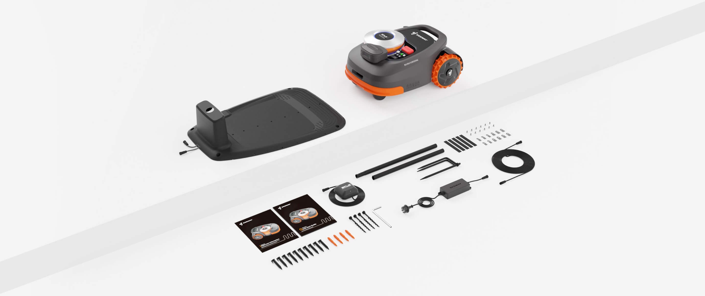 Segway Navimow robot lawn mower with charging station and accessories.