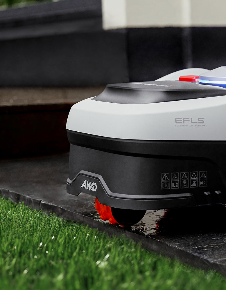 Segway Navimow i110N robot lawn mower is on wet stone.